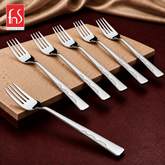 Montavo by FnS Creta 6-piece stainless steel dinner fork set with wavy handle detailing arranged on a raised stone slab.
