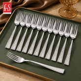 Montavo by FnS Helios 12-piece stainless steel dessert fork set with hammered handles arranged on a premium green tray.