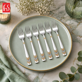 FnS RAGA 6-Pc 24K gold plated stainless steel fruit fork set arranged on a premium plate with decorative handle design