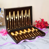 Gold-finished 24-piece cutlery set neatly arranged in a textured brown presentation box with lining.