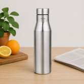 Montavo by FnS Aqua 1 litre stainless steel water bottle on a wooden table with plant and oranges