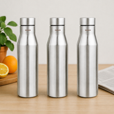 Montavo by FnS Aqua 1 litre stainless steel water bottle set of 3 on a wooden table with plant and oranges