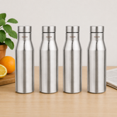Montavo by FnS Aqua 1 litre stainless steel water bottle set of 4 on a wooden table with plant and oranges