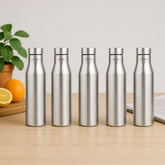 Montavo by FnS Aqua 1 litre stainless steel water bottle set of 5 on a wooden table with plant and oranges