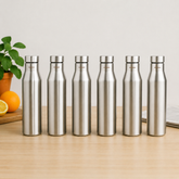 Montavo by FnS Aqua 1 litre stainless steel water bottle set of 6 on a wooden table with plant and oranges