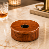 FnS Matto Wooden Finish Steel Ashtray with Lid, round wood-grain design and Centre opening, displayed on a marble counter.
