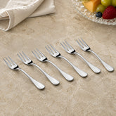 FnS Premium Victoria stainless steel fruit fork set of 6 arranged on a cream marble table with fruit and folded linen.