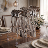 FnS Slim Line stainless steel cutlery set with dinner spoons, forks and teaspoons arranged on a stand on a dining table.