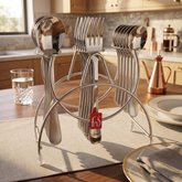 FnS Victoria 18-piece stainless steel cutlery set with spoons and forks displayed on a hanging stand on a dining table.