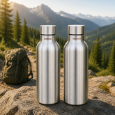 Montavo by FnS Mist 1 litre stainless steel water bottle set of 2 with silver caps displayed on a scenic mountain trail