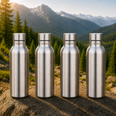 Montavo by FnS Mist 1 litre stainless steel water bottle set of 4 with silver caps displayed on a scenic mountain trail