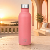Montavo by FnS Sunset Gleam pink stainless steel 750 ml water bottle on an arched terrace at golden hour