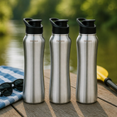 Montavo by FnS Reptide 1 litre stainless steel water bottle set of 3 with black caps displayed on a wooden table by a lake
