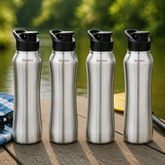 Montavo by FnS Reptide 1 litre stainless steel water bottle set of 4 with black caps displayed on a wooden table by a lake
