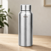 Montavo by FnS Hydra 1 litre stainless steel water bottle with silver finish and steel lid placed on a wooden table.