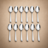 Montavo by FnS Divine 12-piece stainless steel soup spoon set arranged in two rows on a soft champagne luxury background.