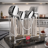 Montavo by FnS Lexia 24-piece stainless steel cutlery set with patterned handles arranged on a metal stand in a kitchen.