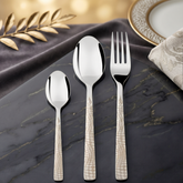 Montavo by FnS Lush 18 Pc laser engraved stainless steel cutlery set with spoon, teaspoon and fork on a black marble table.