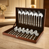 Montavo by FnS Lush 24-piece laser-engraved cutlery set in an open brown leatherette box in a premium dining setting.