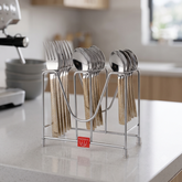 Montavo by FnS Pebble 18-piece laser-engraved cutlery set with spoons and forks arranged on a hanging stand in a kitchen.