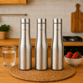 Montavo by FnS Purify 750 ml stainless steel water bottle set of 3 displayed on a woven mat in a warm modern kitchen