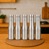 Montavo by FnS Purify 750 ml stainless steel water bottle set of 5 displayed on a woven mat in a warm modern kitchen