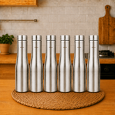 Montavo by FnS Purify 750 ml stainless steel water bottle set of 6 displayed on a woven mat in a warm modern kitchen