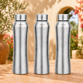 Montavo by FnS Oasis 1 litre stainless steel water bottle set of 3 with silver caps displayed on a sunlit garden table