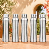 Montavo by FnS Oasis 1 litre stainless steel water bottle set of 5 with silver caps displayed on a sunlit garden table.