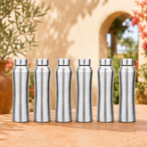Montavo by FnS Oasis 1 litre stainless steel water bottle set of 6 with silver caps displayed on a sunlit garden table