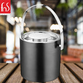 Black finish ice bucket with stainless steel handle and rim on wooden outdoor patio table with blurred restaurant background