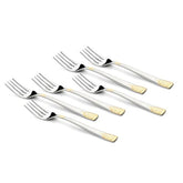Six August Dinner Forks with sleek stainless steel design and 24K gold detailing at the handle ends are laid out in a neat diagonal pattern.