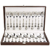 24-piece cutlery set with ornate handles displayed in elegant open brown case with secure interior straps.