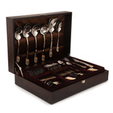 Luxury cutlery collection in polished gold-accented steel, neatly arranged in velvet-lined wooden presentation box.