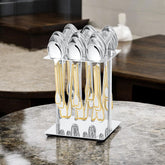 Chrome stand holding complete gold-trimmed cutlery set placed on polished marble surface in modern kitchen.