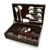Elegant gold-accented cutlery set neatly arranged in a brown presentation box with multiple compartments.