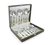 Complete gold-accented cutlery set elegantly organized in a velvet-lined presentation box with white interior.