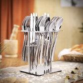 Full 24-piece polished cutlery set in holder, styled on decorative table with warm indoor background.