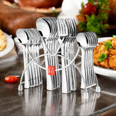 Polished silver cutlery set arranged in a stylish rack, displayed on a dining table with food.