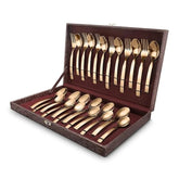 Elegant gold cutlery set in a brown leatherette box with forks and spoons neatly arranged.