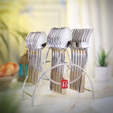 Elegant silver and gold cutlery set in stand, displayed on kitchen counter with natural lighting.