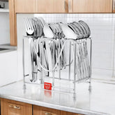 Montalvo stainless steel cutlery set neatly arranged in a chrome stand on a modern countertop.