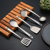 Montavo cooking spoon, turner, and kitchen gadgets arranged on bamboo rest with dark background display.