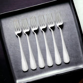 Six stainless steel forks arranged in black presentation box