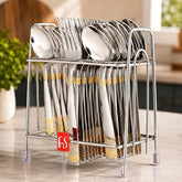 FnS Raga 18-Pc 24K gold plated stainless steel cutlery set with spoons and forks arranged in an elegant storage stand.