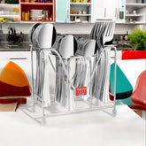 Full stainless steel cutlery set in chrome stand labeled ""Montalvo,"" placed on a modern kitchen counter.