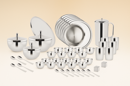 A complete high-quality stainless steel dinner set featuring plates, bowls, glasses, spoons, and serving pots with lids, arranged neatly on a beige background.