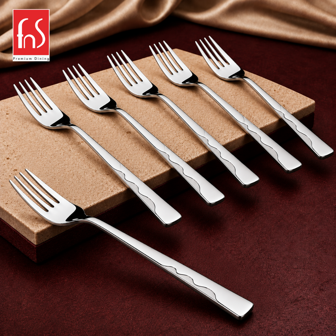 Montavo by FnS Creta 6-piece stainless steel dinner fork set with wavy handle detailing arranged on a raised stone slab.
