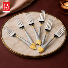 Montavo by FnS Passion 6-piece dinner fork set with real gold-plated accents displayed on a round elegant marble tray.
