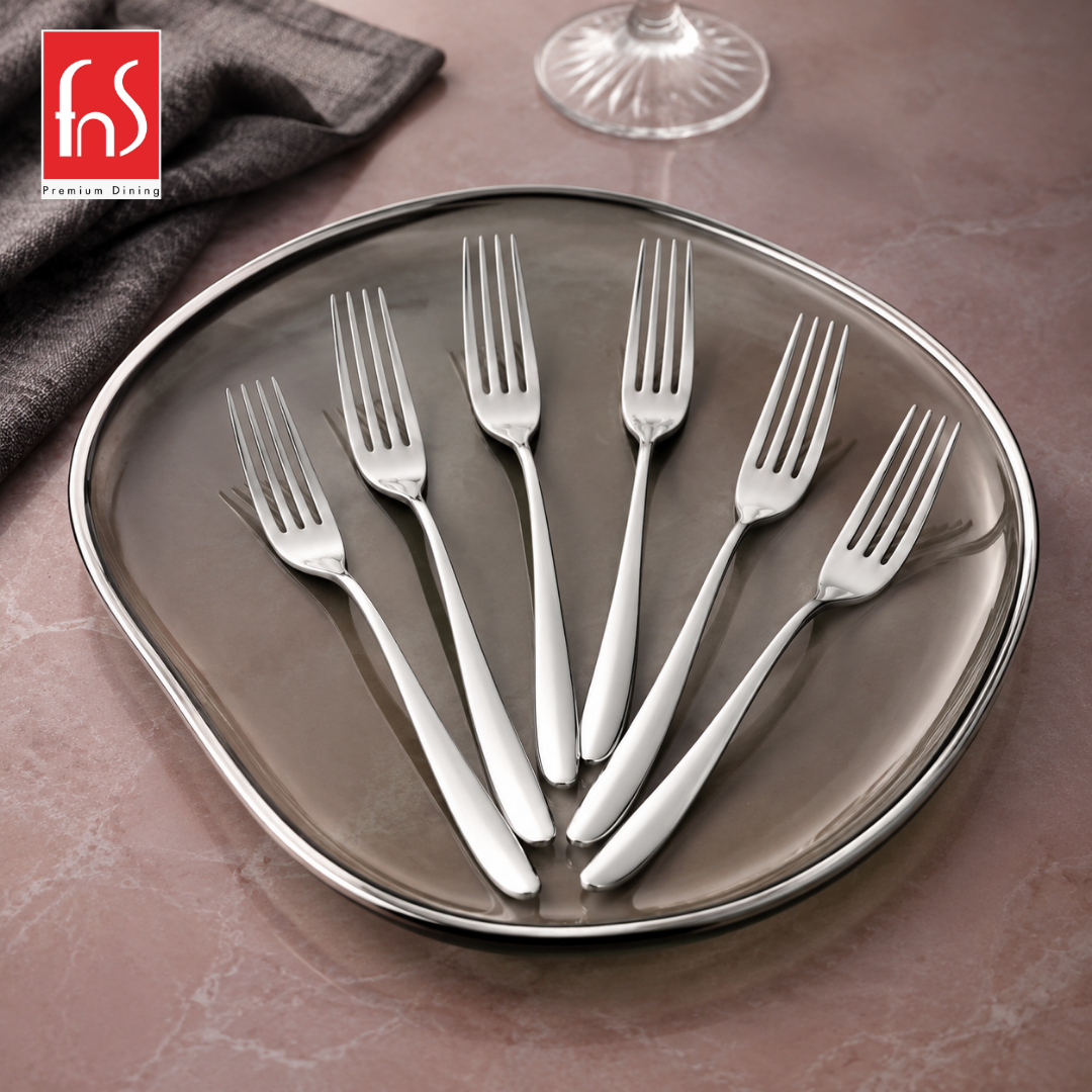 Montavo by FnS Verona 6-piece stainless steel dessert fork set with sleek handles displayed on an elegant silver tray.
